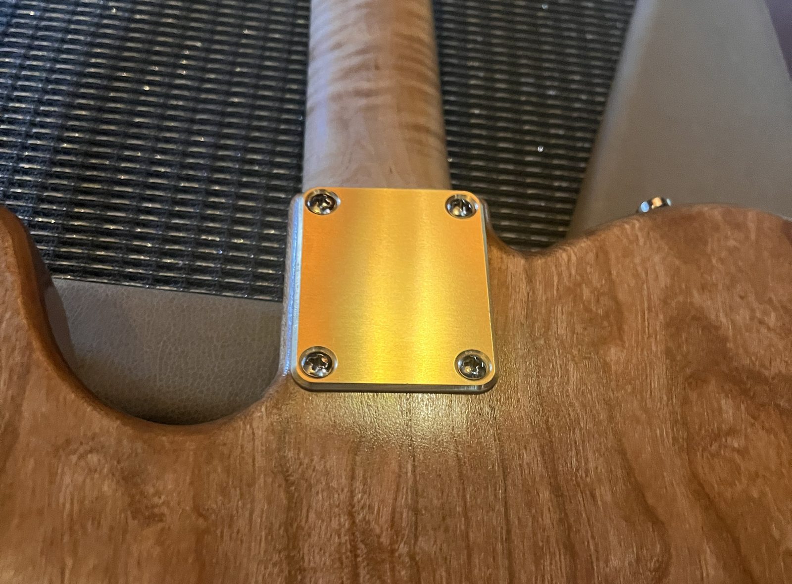 Brass neck plate on Plaincaster guitar