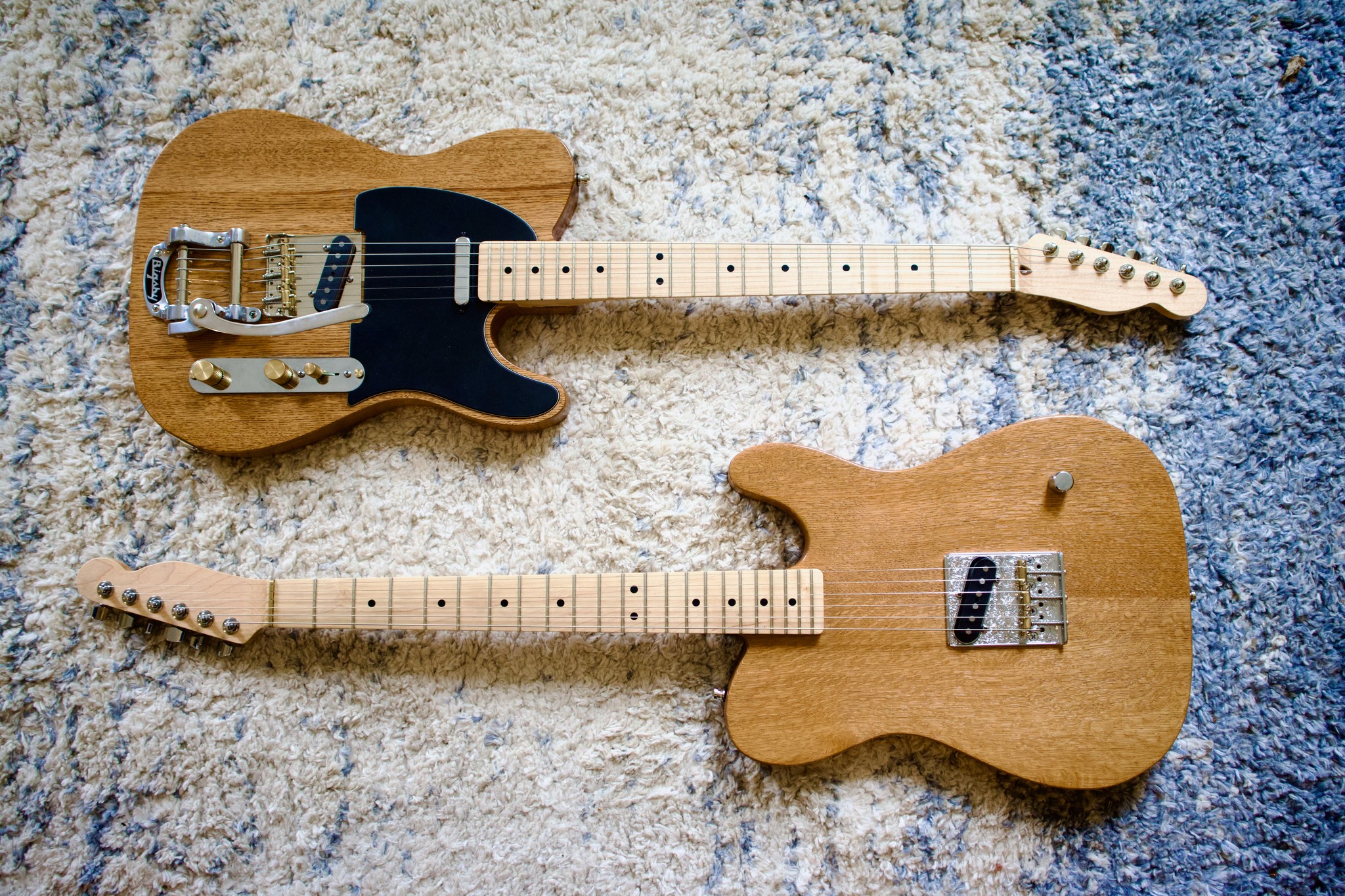 Two Plaincaster guitars side by side